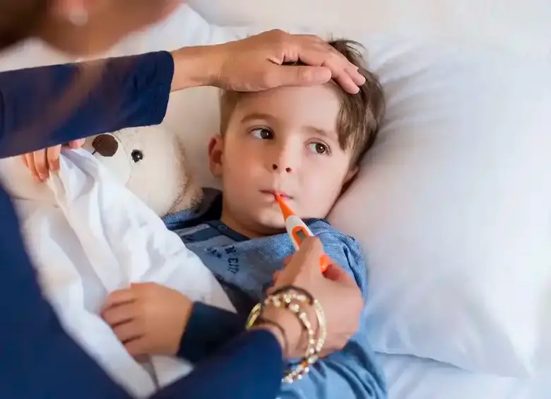 Niño enfermo, recostado en una cama, bajo el cuidado de un adulto, una imagen para graficar la función de la Ley Isaac. FOTO: Getty