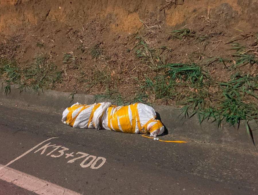 Así encontraron el cuerpo embolsado de esta madrugada en la autopista Norte, en Girardota. FOTO: CORTESÍA