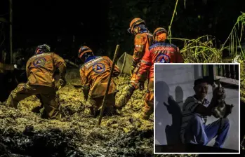 Adelante, uno de los vecinos de San Isidro en Sabaneta junto a una gatica que se salvó de la avalancha. Atrás, miembros de la Defensa Civil durante las labores de búsqueda. Fotos: Andrés Camilo Suárez Echeverry