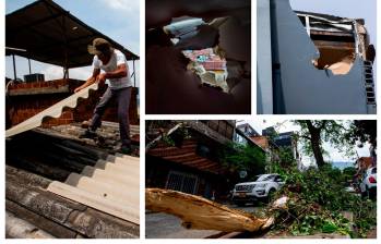 Un hombre pone de nuevo las tejas de su vivienda en el barrio Aranjuez, oriente de Medellín, luego que el ventarrón de la madrugada afectara parte del techo. En la calle 92 se registraron varios árboles caídos por los fuertes vientos que sacudieron al área metropolitana. FOTOS JULIO CÉSAR HERRERA