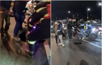 Momento en el que varios ciudadanos se detuvieron a ayudar a la motociclista afectada, para atenderla y ayudarle a sacar la moto del hueco. FOTO: Captura video @santiagolopezp
