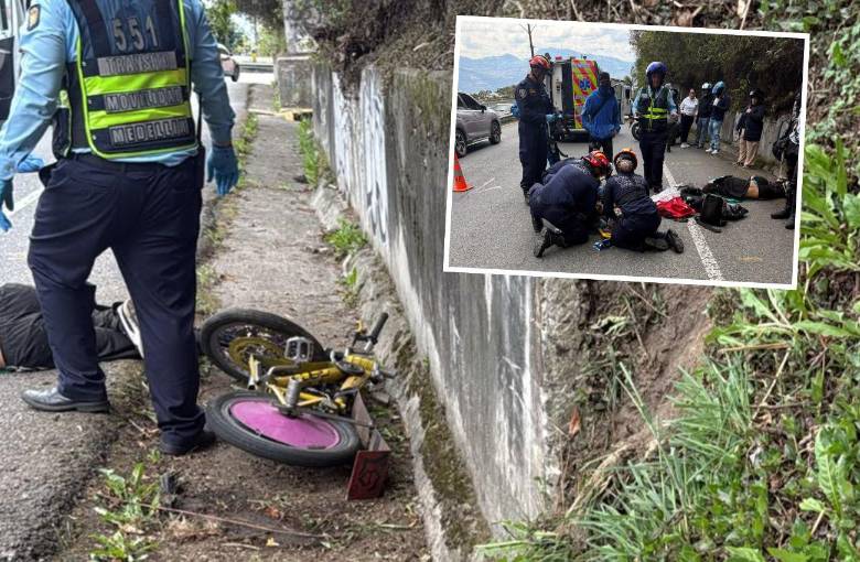 Un hombre y una mujer se descolgaban en una bicicleta y golpearon contra el barranco y el pavimento. Agentes de la Policía Judicial de la Secretaría de Movilidad de Envigado atienden el accidente. FOTOS: CORTESÍA
