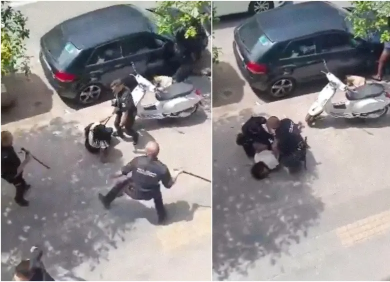 La joven colombiana siendo golpeada y retenida por los policías en medio de la calle. FOTO: Captura de video
