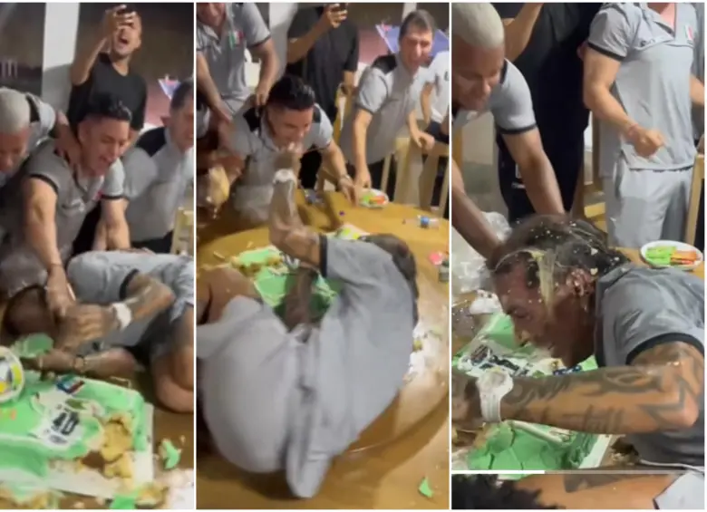Compañeros de Dayro Moreno echándole la torta encima mientras rodaba en la mesa. FOTO: Captura video redes sociales @juanfcastano16