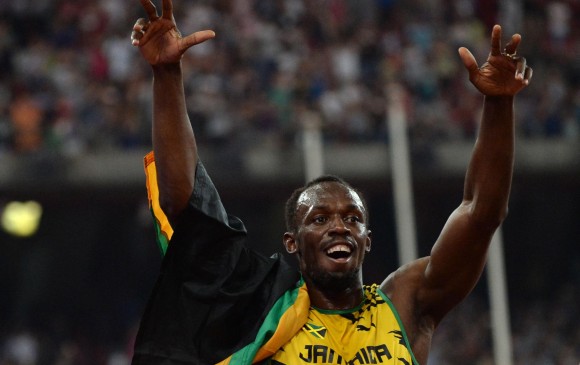 Usain Bolt y la expresión de felicidad tras el triunfo con Jamaica en el relevo 4x100 en el Mundial de atletismo. FOTO AFP