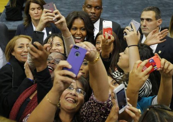 Reuters - Michelle Obama posa con el p&#250;blico que asiste a una reuni&#243;n de campa&#241;a para la candidata dem&#243;crata Gina Raimondo.