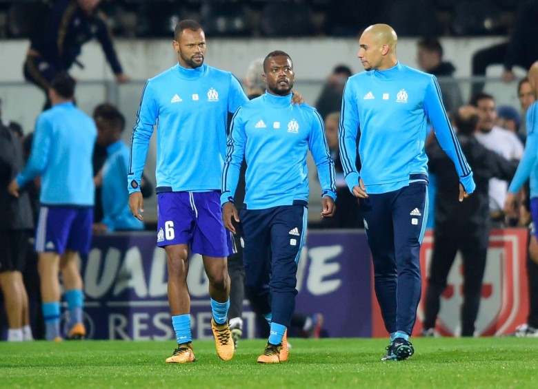Patrice Evra (centro) no logró controlarse tras los insultos del aficionado del Olympique. FOTO: AFP