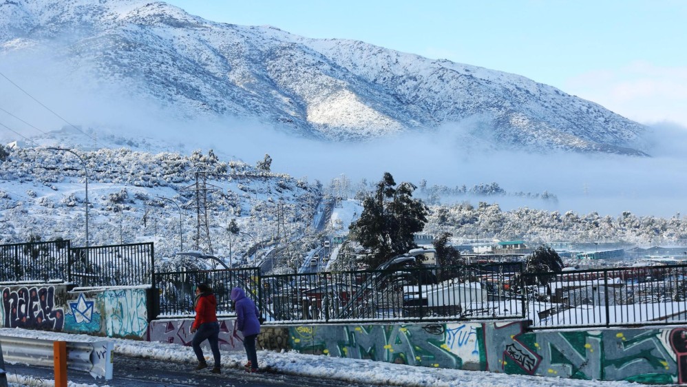 La capital chilena se vio afectada este sábado por la mayor nevada de la última década, un fenómeno que dejó a más de 300.000 hogares sin suministro eléctrico y que se repitió en otras regiones del país. FOTOS EFE Y REUTERS