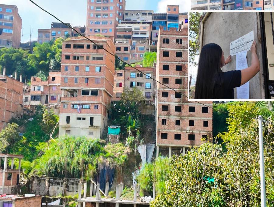 Adelante, una funcionaria realizando un sellamiento. Atrás,algunas de las viviendas investigadas. FOTO: Cortesía