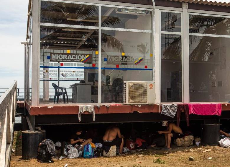 Migrantes viven bajo la sede de Migración Colombia en el puerto de Necoclí. Foto: Carlos Velásquez
