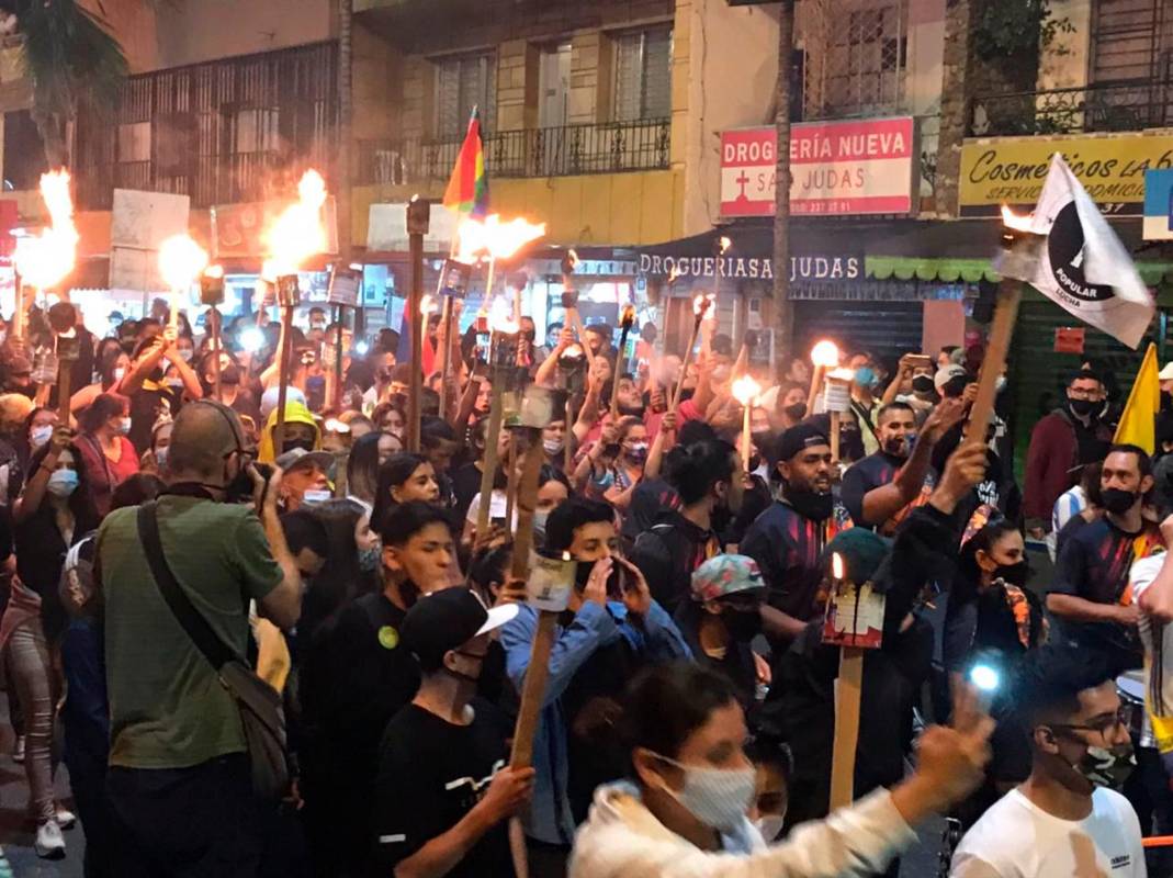 A esta hora avanza, en completa calma, una marcha de antorchas en la comuna 5, barrio Castilla de Medellín. Foto Julio César Herrera