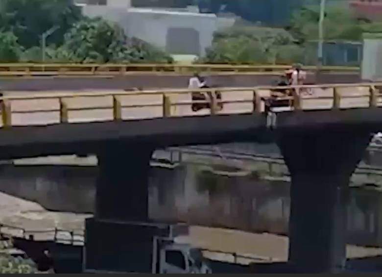 Mujer que se iba a lanzar de un puente en Medellín. FOTO: CAPTURA VIDEO