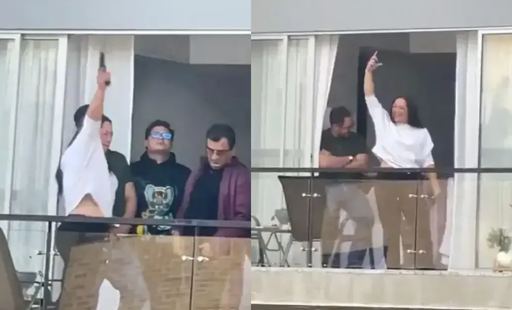 La mujer generó revuelo al disparar al menos cinco veces al aire desde el piso 12 de un conjunto residencial en Bogotá. FOTO: Captura de video