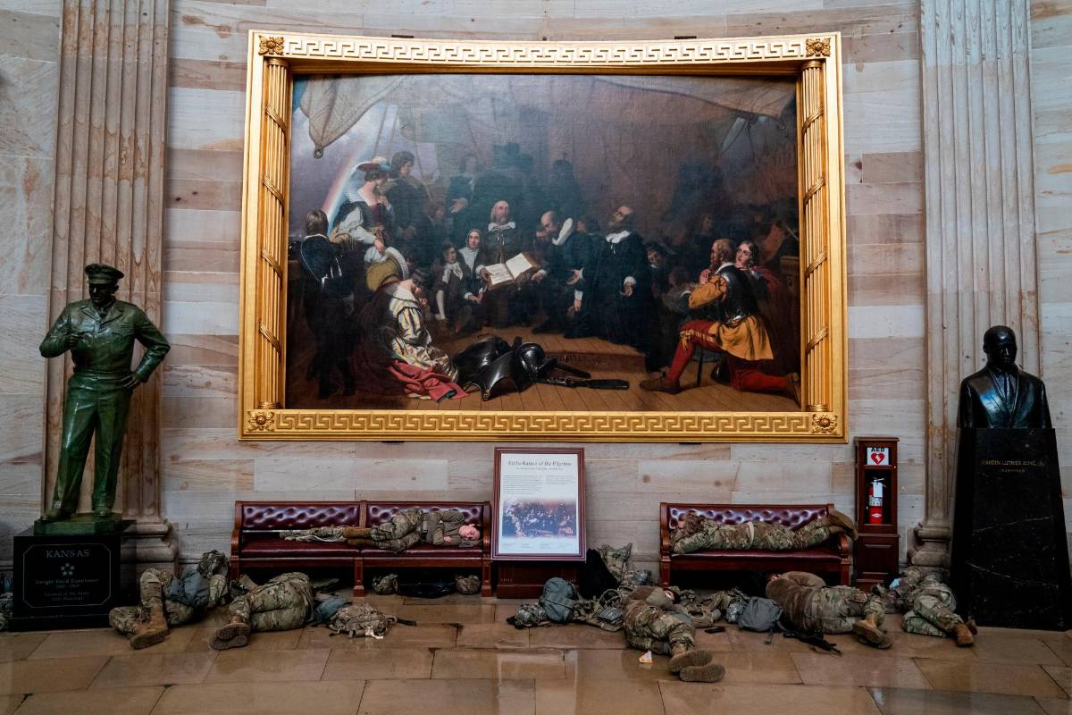 Miembros de la Guardia Nacional de los Estados Unidos duermen en los pasillos del Capitolio para prevenir nuevos desmanes, horas antes del debate por el juicio político a Donald Trump por la invasión de este recinto por parte de sus seguidores. Fotos: Kent Nishimura (Los Angeles Times) vía Getty.