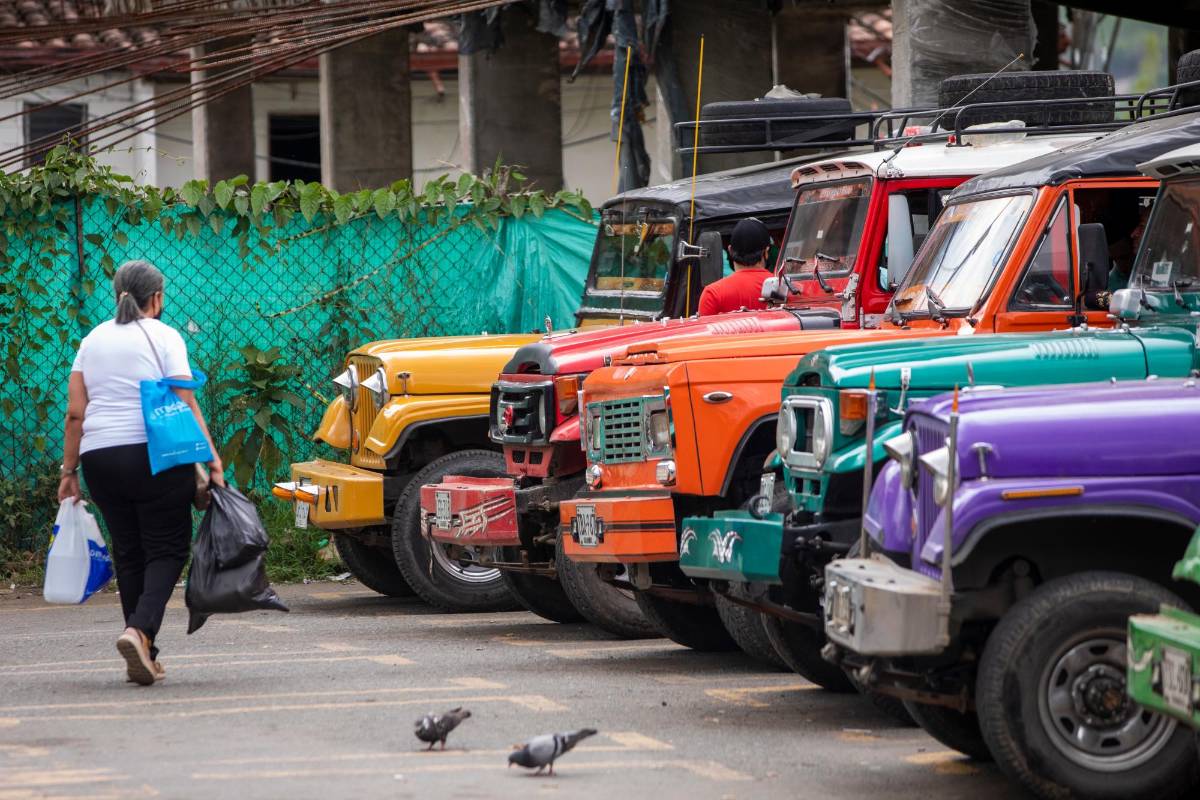 Todos los días al frente de la plaza de mercado de Girardota se forma una fila de coloridos camperos antiguos. Son la flota de transporte veredal Expreso Girardota. Foto: Carlos Velásquez