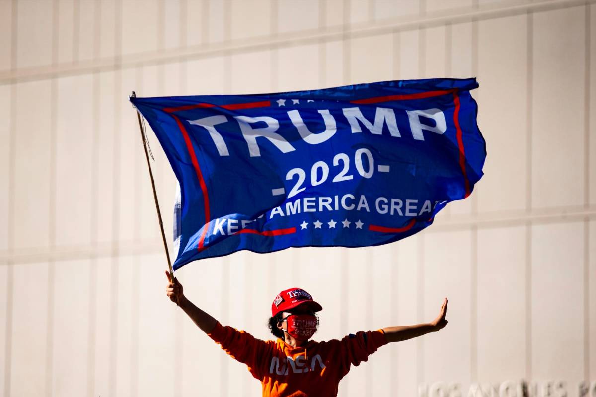 En las escalinatas del Capitolio se les veía ondear la bandera electoral con la que Trump buscó infructuosamente la reelección. Foto: EFE