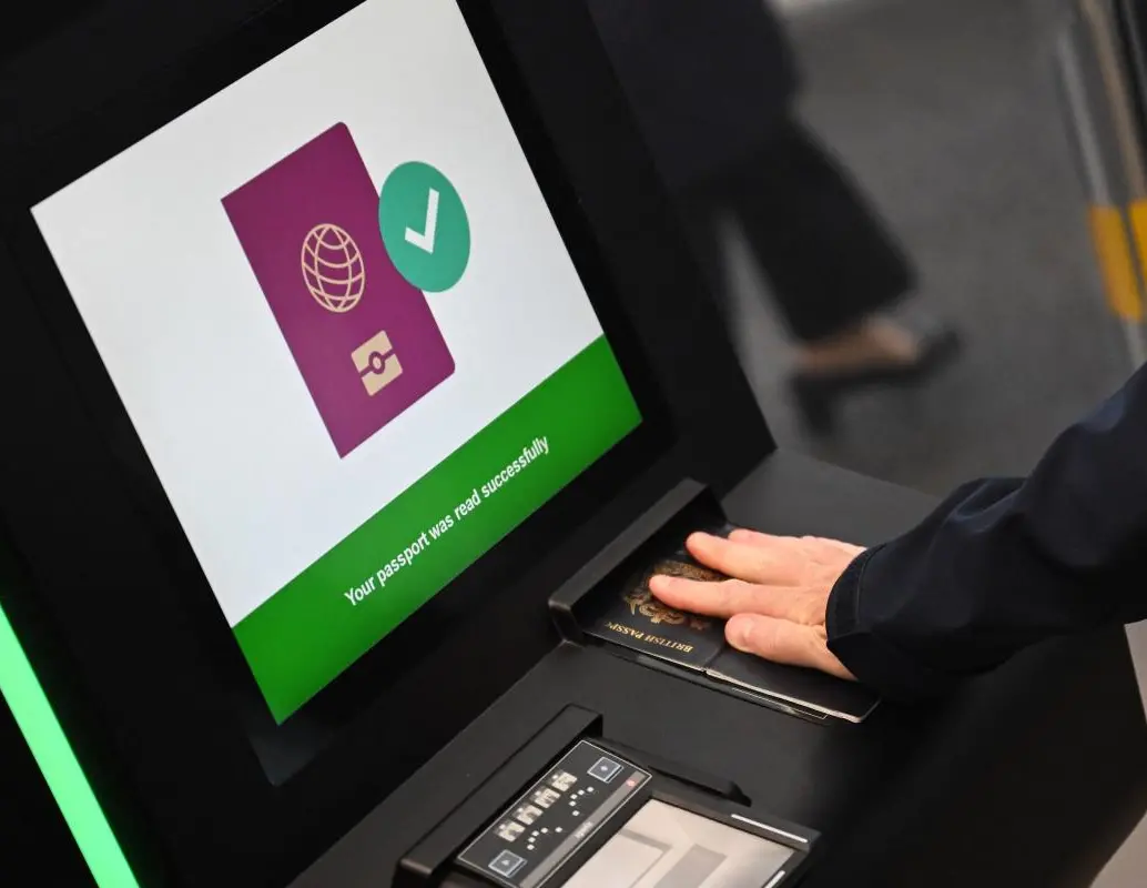 Una persona escaneando su pasaporte en una máquina. FOTO: AFP