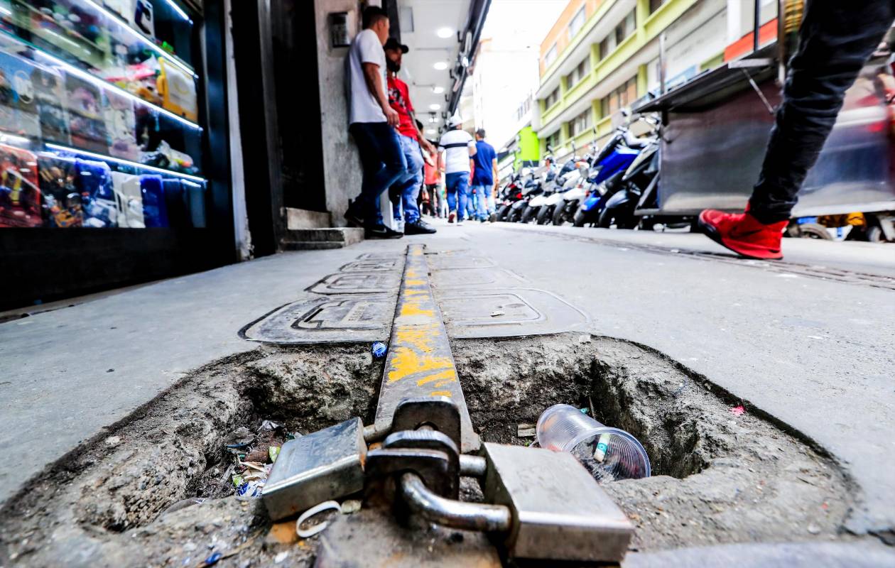 Debido a la inseguridad que se vive en algunos sectores de la ciudad, los vecinos han decidido asegurar las tapas de los medidores con candados para que no sean robadas. FOTO: JAIME PÉREZ
