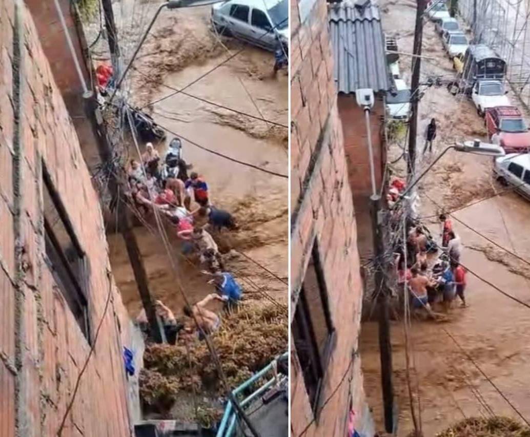 Un grupo de personas rescató a un hombre de la corriente en el barrio Manrique de Medellín. FOTOS: Capturas de video 