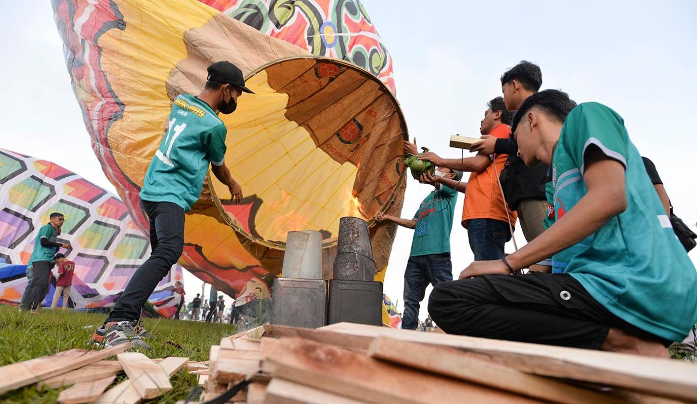Miles de personas se reúnen en campos abiertos para lanzar globos al cielo, creando un espectáculo visual impresionante. Foto: GETTY