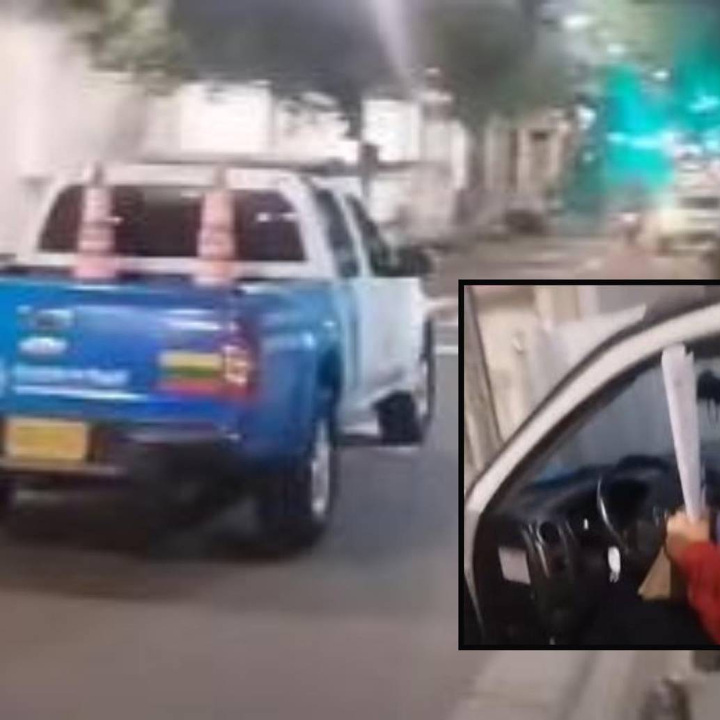 Adelante, el conductor del vehículo, quien sería un agente de tránsito, llevando lo que según la denuncia sería un pendón de una campaña política. Atrás, el vehículo oficial implicado. FOTO: imagen tomada de redes