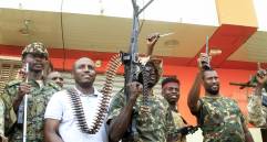 Un hombre posa con soldados del ejército sudanés en Salha, al sur de Omdurman, un día después de haber recuperado la zona de manos de las fuerzas paramilitares de Apoyo Rápido (RSF), el 21 de mayo de 2025. Desde su estallido en 2023, Sudán ha sido devastado por la guerra entre las RSF y el ejército, alimentada por intereses regionales contrapuestos que incluyen a los Emiratos Árabes Unidos, Egipto, Arabia Saudita e Irán. Mercenarios extranjeros han aparecido en ambos bandos del conflicto. (Foto de Ebrahim Hamid / AFP)