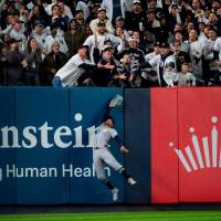 Esta fue la insólita imagen en la que se ve la intervención del aficionado, lo que evitó el jonrón de los Yankees. FOTO getty