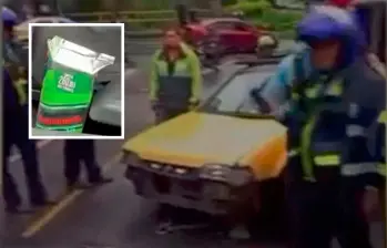 El conductor de este vehículo amarillo se le encontró una caja de aguardiente al lado de su asiento. Cuando le iban a inmovilizar el carro, arrolló a un agente de tránsito. FOTO: CORTESÍA