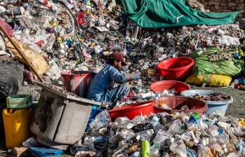 Un trabajador afgano clasifica el plástico reciclable recogido en un depósito de reciclaje en las afueras de Kabul. FOTO: AFP