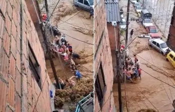 Un grupo de personas rescató a un hombre de la corriente en el barrio Manrique de Medellín. FOTOS: Capturas de video 