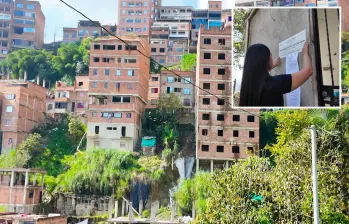 Adelante, una funcionaria realizando un sellamiento. Atrás,algunas de las viviendas investigadas. FOTO: Cortesía