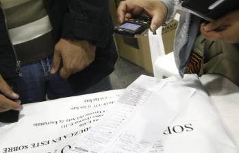 Testigo electoral toma una fotografía del formulario E-14 con su celular. Foto: Colprensa - Christian Castillo