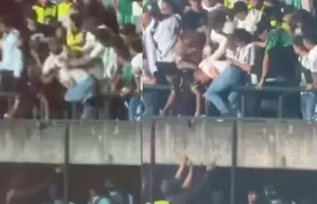 Un hincha cayó de las gradas a la pista atlética del estadio Ditaires tras ser golpeado por seguidores del Nacional. Foto: Captura videos redes sociales