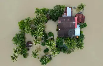 Equipos de rescate trasladan a sobrevivientes entre calles inundadas en el sur de Asia. FOTO: AFP. 