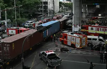 El accidente entre un tren y un autobús provocó un incendio en una concurrida zona de Bangkok. FOTO: AFP.