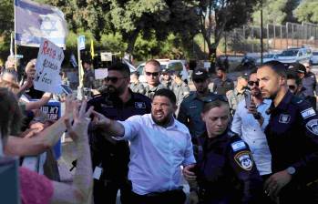 El miembro del parlamento israelí Almog Cohen (C) discute con activistas que se manifiestan frente al Parlamento israelí. FOTO: AFP