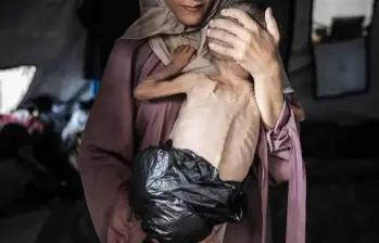 Esta es la foto de Hedaya al-Muta cargando en brazos a su hijo Mohamed Zakariya Ayyoub al-Matouq, de 1 año, en medio de la hambruna de Gaza. FOTO: Getty-Ahmed al-Arini