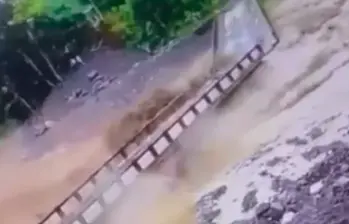 Momento en el que el agua arrastra el puente Largo de Carepa. FOTO: Captura de video