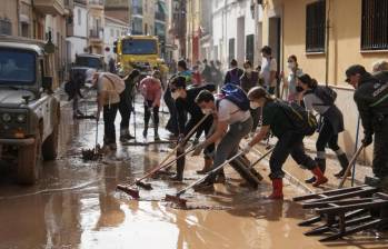 Una de tantas comunidades todavía intentando sacar el agua de sus hogares en la ciudad de Valencia, España, tras sufrir las repercusiones del fenómeno Dana. Ahora esperan la ayuda del gobierno. FOTO: AFP