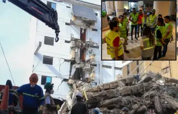 Atrás, uno de los edificios afectados por el terremoto en Cali. Adelante, sesión conjunta con funcionarios del AMVA. FOTO: Cortesía