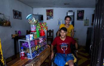 Jorge y Yuliana saliendo de su casa en Santo Domingo Savio, y junto a ellos, su vitrina con confites. FOTO: Julio César Herrera 