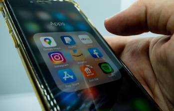 Cagliari, Sardinia, Italy: AUG 10 2021: close up hand holding a mobile phone with a screen of various applications, amazon, just eat, ebay, paypal, spotify