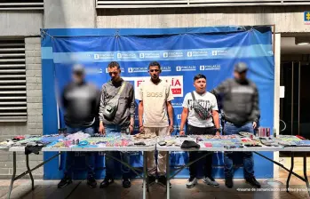 Tres de los capturados en Barrio Antioquia y parte de la mercancía incautada. FOTO Cortesía Secretaría de Seguridad de Medellín.
