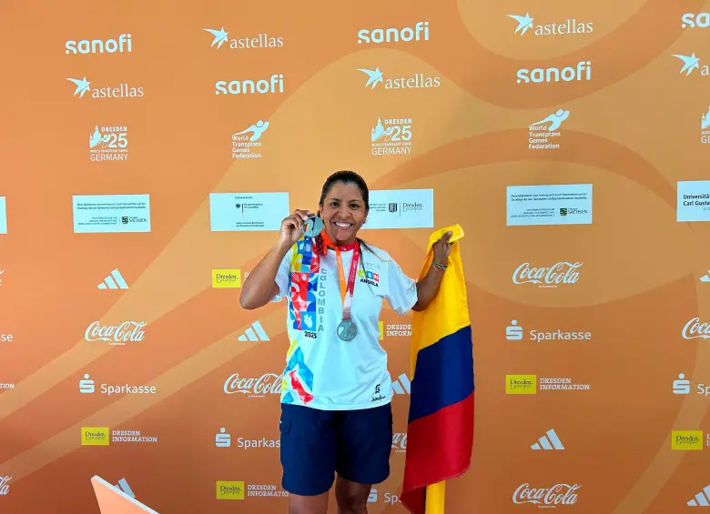 Festejando una de las múltiples medallas que alcanzó, con una sonrisa de satisfacción.