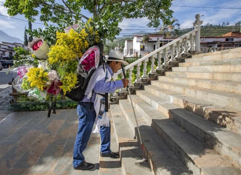 Jorge cargando su silleta improvisada con la que surte de flores su negocio en Copacabana. Foto: Esneyder Gutiérrez