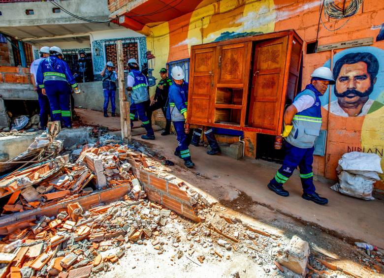 Con apoyo de los funcionarios de la Alcaldía de Medellín, las familias desalojadas sacan sus pertenencias y las llevan en camiones a bodegas o a las casas donde se van a albergar. FOTO JULIO CÉSAR HERRERA