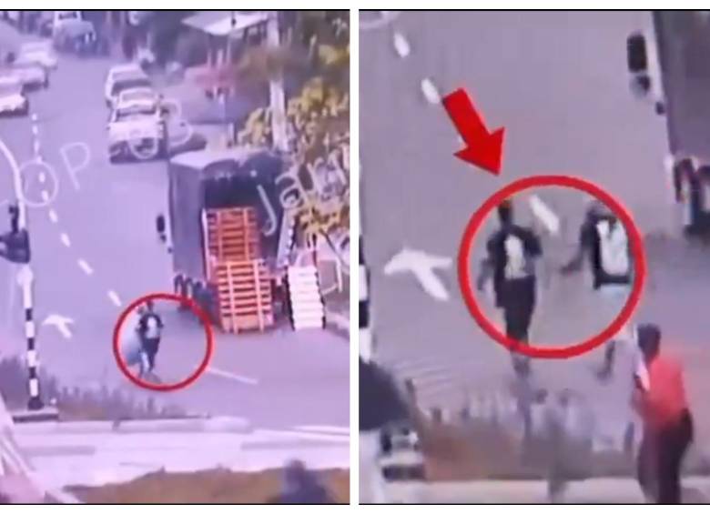 Los dos sujetos captados por una cámara de seguridad del sector, justo antes de arrojar el colchón a la vía pública. FOTO Cortesía X Federico Gutiérrez.