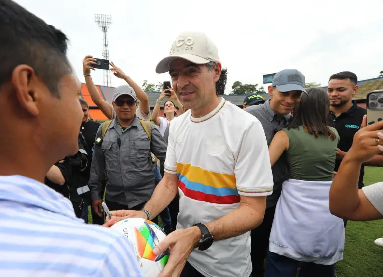 El alcalde de Medellín haciendo entrega del balón firmado al joven. FOTO: Cortesía Alcaldía de Medellín