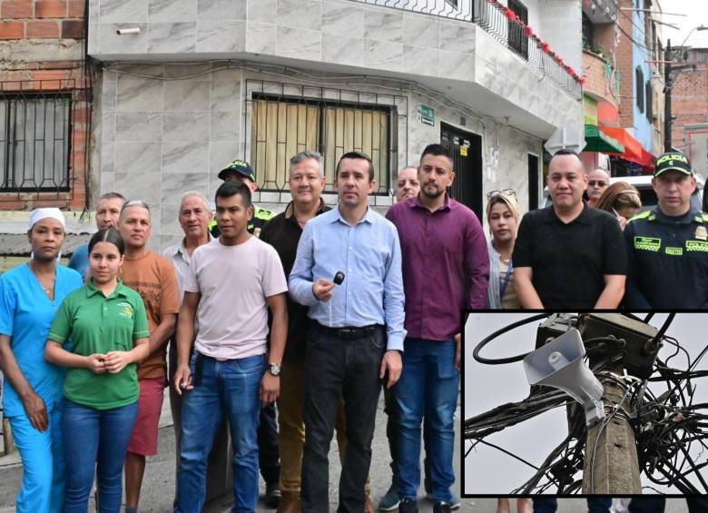 Adelante, una de las alarmas entregadas a la comunidad. Atrás, el secretario de Seguridad hace entrega de los botones de pánico a comerciantes itagüiseños. FOTO: Cortesía