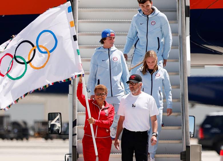 La alcaldesa de Los Ángeles, Karen Bass, con la bandera de los Juegos Olímpicos bajándose de un avión en su ciudad. FOTO: Olímpicos de Los Ángeles 2028